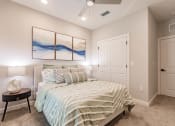 Thumbnail 33 of 57 - a bedroom with a bed and a ceiling fan at swiftwater luxury apartments in port charlotte, fl
