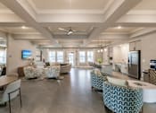 Thumbnail 21 of 94 - community lounge area with chairs and tables at Vantage Luxury Apartments in  Cape Coral, FL
