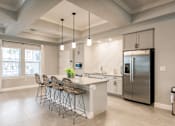 Thumbnail 25 of 94 - community kitchen with a chairs, a bar, and appliances at Vantage Luxury Apartments in  Cape Coral, FL