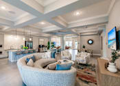Thumbnail 20 of 94 - lounge area with a large couch, chairs, and a kitchen in the background at Vantage Luxury Apartments in  Cape Coral, FL