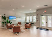 Thumbnail 24 of 94 - lounge area with chairs and a tv at Vantage Luxury Apartments in  Cape Coral, FL