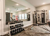 Thumbnail 32 of 94 - fitness center with dumbbells and a machine at Vantage Luxury Apartments in  Cape Coral, FL