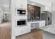 Thumbnail 43 of 51 - A modern kitchen with a refrigerator, oven, and sink.