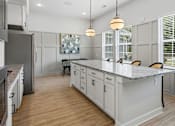 Thumbnail 45 of 51 - A kitchen with white cabinets and a granite countertop.