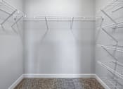 Thumbnail 26 of 51 - Empty pantry with shelves and a carpeted floor.