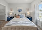 Thumbnail 5 of 51 - A bedroom with a large bed and two lamps.