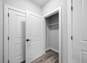 Thumbnail 17 of 51 - A white closet with a shelf and a door open.