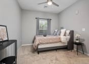 Thumbnail 31 of 42 - a bedroom with a bed and a ceiling fan