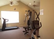 Thumbnail 7 of 14 - Fitness area with a large window and a treadmill at Maple Tree Apartments in LaPorte, IN