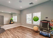 Thumbnail 29 of 94 - a workout room with a treadmill and weights and a window