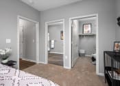 Thumbnail 32 of 42 - a bedroom with three doors open to a bathroom and a closet