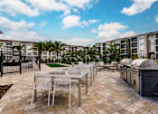 Thumbnail 10 of 94 - chairs, tables, and grills at Vantage apartments in cape coral, fl