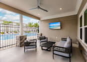 Thumbnail 8 of 94 - a patio with a couch and chairs next to a pool