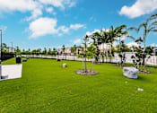 Thumbnail 12 of 94 - dog park with green turf and a fence at Vantage Luxury Apartments in  Cape Coral, FL