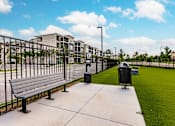 Thumbnail 13 of 94 - dog park with green turf and a fence at Vantage Luxury Apartments in  Cape Coral, FL