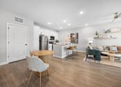 Thumbnail 3 of 83 - A modern kitchen with a dining table and chairs.