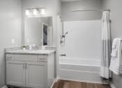 Thumbnail 40 of 42 - a bathroom with a shower and a sink and a mirror