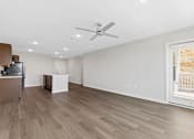 Thumbnail 12 of 58 - A room with a ceiling fan and wooden flooring.