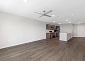 Thumbnail 9 of 58 - A room with a ceiling fan and wooden flooring.