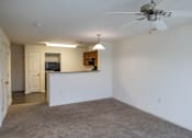 Thumbnail 31 of 41 - A spacious living room with a ceiling fan and a flat screen TV.