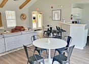 Thumbnail 5 of 17 - a dining room and living room with a table and chairs
