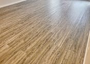 Thumbnail 9 of 17 - an empty living room with wood floors and a ceiling fan