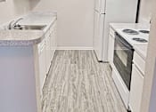 Thumbnail 8 of 17 - an empty kitchen with white appliances and white cabinets