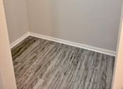 Thumbnail 13 of 17 - an empty closet in a home with wood flooring