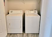 Thumbnail 16 of 17 - a washer and dryer in a room with wood floors and a closet