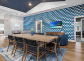 Thumbnail 4 of 42 - a dining room with a wooden table and chairs