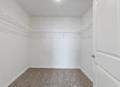 Thumbnail 27 of 58 - Empty room with white walls and carpeted floor.