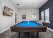 Thumbnail 16 of 42 - a games room with a pool table and a tv