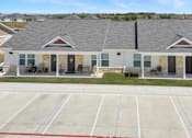 Thumbnail 49 of 58 - A building with a parking lot in front of it.