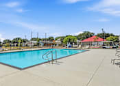 Thumbnail 30 of 45 - A large swimming pool with a diving board in the middle.