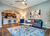Thumbnail 29 of 34 - Living Room with couch, table, and chairs at the Flats at Sundown in North Port, Florida