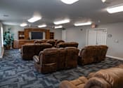 Thumbnail 14 of 41 - A room with brown leather chairs and a television.
