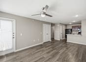 Thumbnail 35 of 45 - A room with a ceiling fan and wooden flooring.