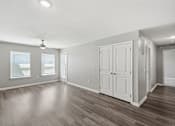 Thumbnail 36 of 45 - A room with a ceiling fan and wooden flooring.