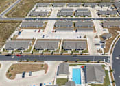 Thumbnail 48 of 58 - A bird's eye view of legacy square senior apartments and a swimming pool.