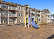 Thumbnail 18 of 42 - A playground with a slide at Aurora apartments