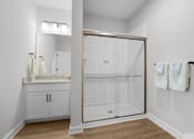 Thumbnail 37 of 83 - A white bathroom with a walk in shower.