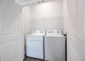 Thumbnail 51 of 83 - A white bathroom with two sinks and a door.