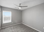 Thumbnail 44 of 45 - A room with a ceiling fan and a window with blinds.