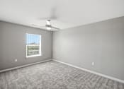 Thumbnail 39 of 45 - A room with a carpeted floor and a window.