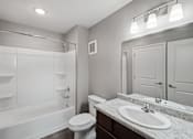 Thumbnail 45 of 45 - A white bathroom with a toilet, sink, and bathtub.