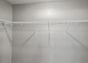 Thumbnail 37 of 45 - A white closet with a metal rack.