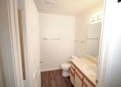Thumbnail 5 of 5 - A white bathroom with a toilet, sink and mirror.