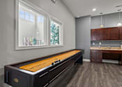 Thumbnail 8 of 34 - A pool table is in the middle of a room with a window and a sink.