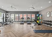 Thumbnail 17 of 34 - A spacious gym with a variety of equipment and a large mirror on the wall.