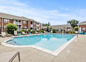 Thumbnail 14 of 34 - A swimming pool surrounded by a fence and chairs.